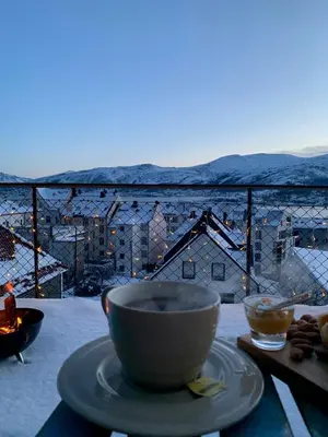 a cup of coffee sitting on a table with a view at City View Studio Apartment in Ålesund