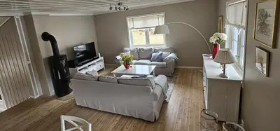 a living room with two couches and a tv at Voss Interlake - Villa in Skulestadmo