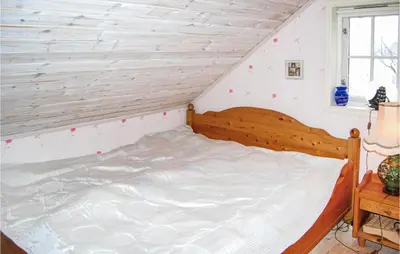 a bedroom with a wooden bed in a room at Gorgeous Home In Førde I Hordaland in Førde