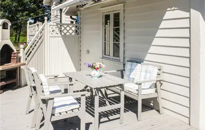 a wooden table and two chairs on a porch at Gorgeous Home In Førde I Hordaland in Førde