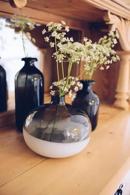 three vases with flowers in them sitting on a table at Dalhus - House with jacuzzi in Norddal