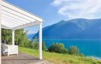 a white pergola with a view of a lake at Nice Home In Ornes With House Sea View in Ornes