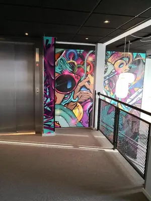 a hallway with a mural on the wall at Birkebeineren Hotel & Apartments in Lillehammer