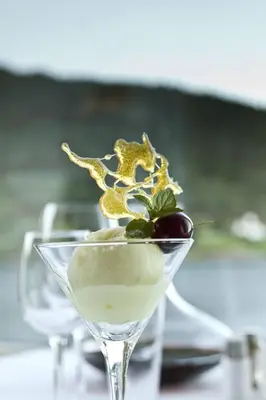 a dessert in a martini glass with a cherry at Kviknes Hotel in Balestrand