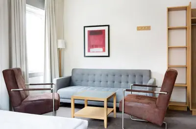 a living room with a couch and two chairs at Comfort Hotel Fosna in Kristiansund