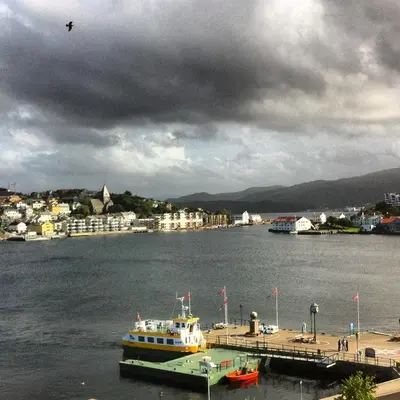 a boat docked at a dock in a body of water at Comfort Hotel Fosna in Kristiansund
