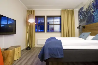 a bedroom with a large bed and a window at Scandic Hafjell in Hafjell