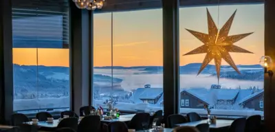 a dining room with a large star on the window at Beito Resort Hotel in Beitostøl
