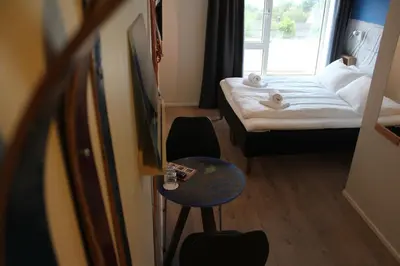 a small hotel room with a bed and a table at Stasjonen Hotel in Lillehammer