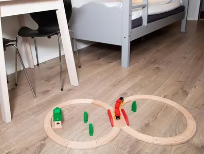 a toy train on a track in a room with a bed at Stasjonen Hotel in Lillehammer