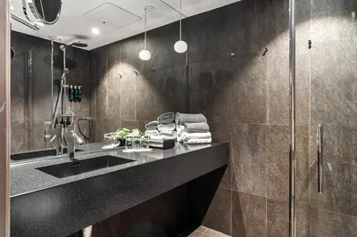 a bathroom with a sink and a shower at Clarion Hotel Admiral in Bergen