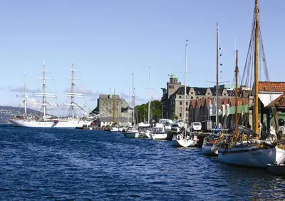 a bunch of boats are docked in a harbor at Home Hotel Havnekontoret in Bergen