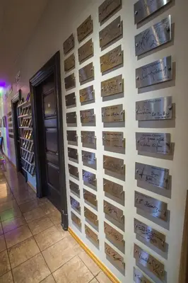 a wall of wine signs in a wine cellar at Home Hotel Havnekontoret in Bergen