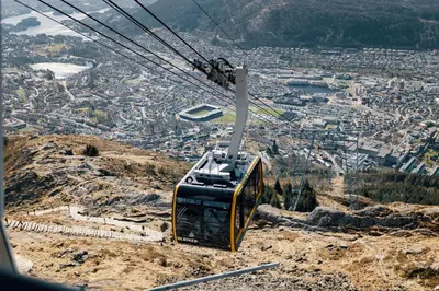 a gondola flying over a city on a mountain at Quality Hotel Edvard Grieg in Bergen