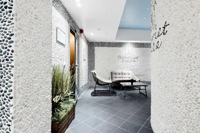 a waiting room with a chair and a table at Best Western Plus Hotel Bakeriet in Trondheim