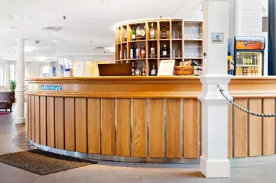 a wooden bar in a restaurant with a counter at Best Western Plus Hotel Bakeriet in Trondheim