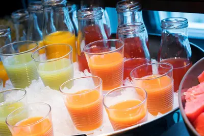a tray with many glasses of oranges and juice at Thon Hotel Bristol, Bergen in Bergen