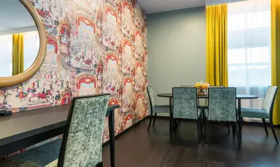 a dining room with a table and chairs and a mirror at Thon Hotel Bergen Airport in Bergen