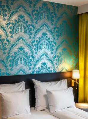a bedroom with a blue and white damask wallpaper at Thon Hotel Rosenkrantz Bergen in Bergen