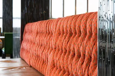 an orange couch in a room with a table at Thon Hotel Orion in Bergen