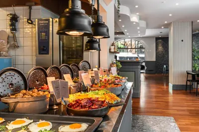 a buffet line with many plates of food at Home Hotel Bryggen in Bergen