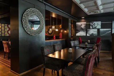 a dining room with a table and chairs and a mirror at Quality Hotel Sogndal in Sogndal