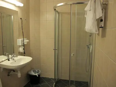 a bathroom with a shower and a sink at Chesterfield Hotel in Trondheim