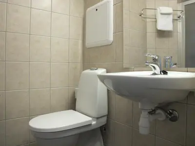 a bathroom with a toilet and a sink at Chesterfield Hotel in Trondheim