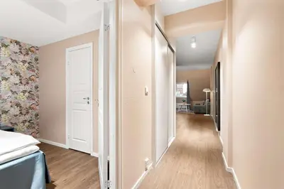 a corridor of a room with a bed and a door at Ole Bull, Best Western Signature Collection in Bergen