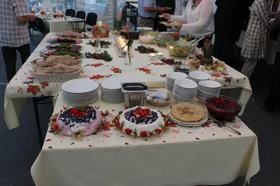 a long table with plates and cakes on it at Trædal Hotel in Sunndalsøra