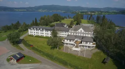 an aerial view of a large building with a lake at Thon Hotel Selbusjøen in Selbu