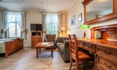 a living room with a couch and a table at Thon Hotel Selbusjøen in Selbu