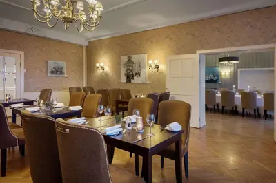 a dining room with tables and chairs and a chandelier at Scandic Alexandra Molde in Molde
