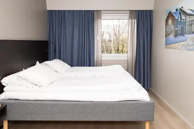 a bed in a room with a window at Thon Hotel Backlund in Levanger