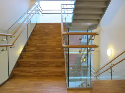 a staircase in a building with a glass railing at Hotel St. Olav in Trondheim