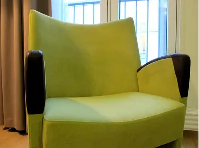 a green chair sitting in front of a window at Hotel St. Olav in Trondheim