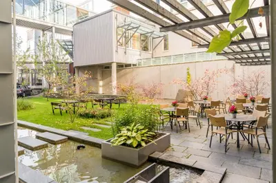 a patio with tables and chairs in a building at Hotel St. Olav in Trondheim