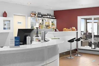 a bar in a restaurant with a counter and chairs at Stav Hotel in Malvik