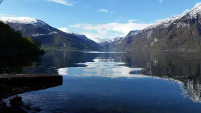 a view of a lake with snow covered mountains at Steinshølen Holiday Home in Flåm