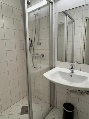 a bathroom with a sink and a shower at Thon Hotel Baronen in Ålesund