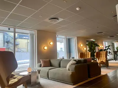 a living room with a couch and some chairs at Comfort Hotel Park in Trondheim