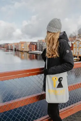 a woman wearing a bag with a penguin on it at Comfort Hotel Park in Trondheim