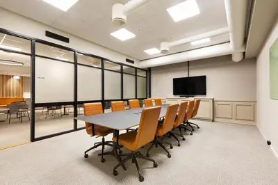 a conference room with a table and chairs and a screen at Quality Hotel Augustin in Trondheim