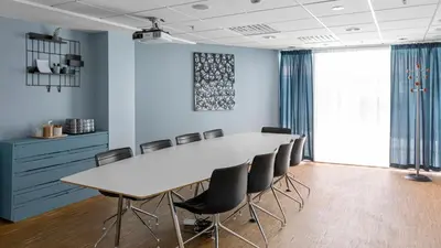 a conference room with a white table and chairs at Comfort Hotel Trondheim in Trondheim