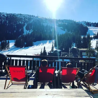 a group of people sitting in chairs on a ski slope at Kvitfjell Hotel Kvitfjellvegen 492 in Kvitfjell