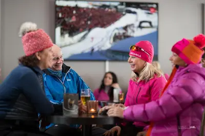 a group of people sitting around a table wearing hats at Ustedalen Hotel Geilo in Geilo