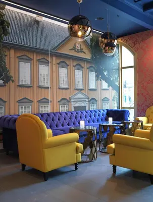 a waiting room with couches and tables and a large window at Thon Hotel Nidaros in Trondheim