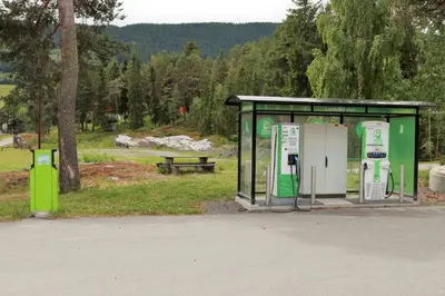 a bus stop with two gas pumps in a park at Furulund Pensjonat in Ron
