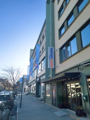a city street with buildings and cars parked at City Living Sentrum Hotel in Trondheim