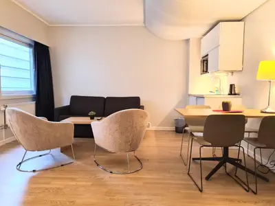 a living room with a table and chairs and a couch at City Living Sentrum Hotel in Trondheim